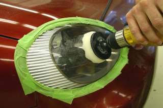 Refining and buffing a clouded headlight lens using components 