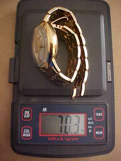 Solid 14k gold case and band. Total weight 70.3 grams. In original 