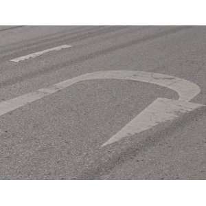  U Turn Arrow Painted onto a Faded Blacktop Road Stretched 