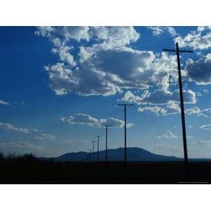  Silhouetted Telephone Poles under Puffy Clouds National 