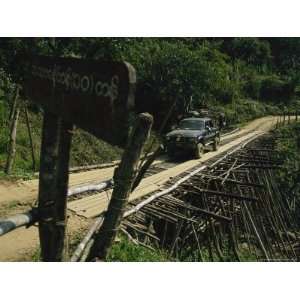  A Truck Carefully Making its Way Across a Rickety Looking 