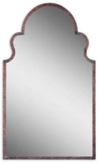 This shaped mirror features a hand forged metal frame finished in 