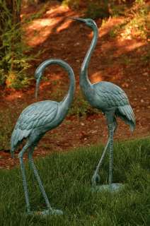 this graceful pair of crane garden statues are made of bronze and 